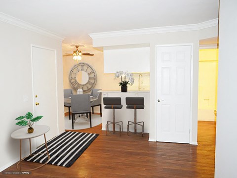 a living room and dining room with a table and chairs